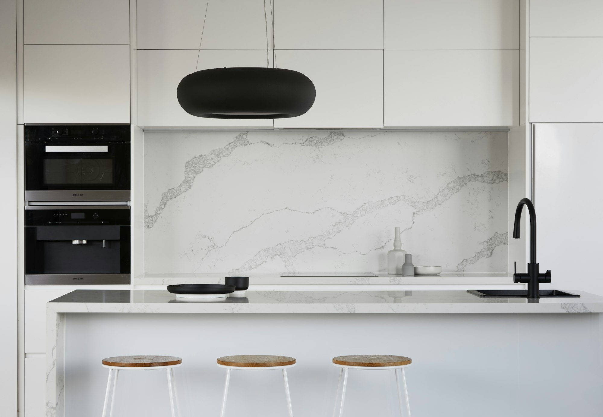 High-end renovated kitchen with marble island by Vail and Co